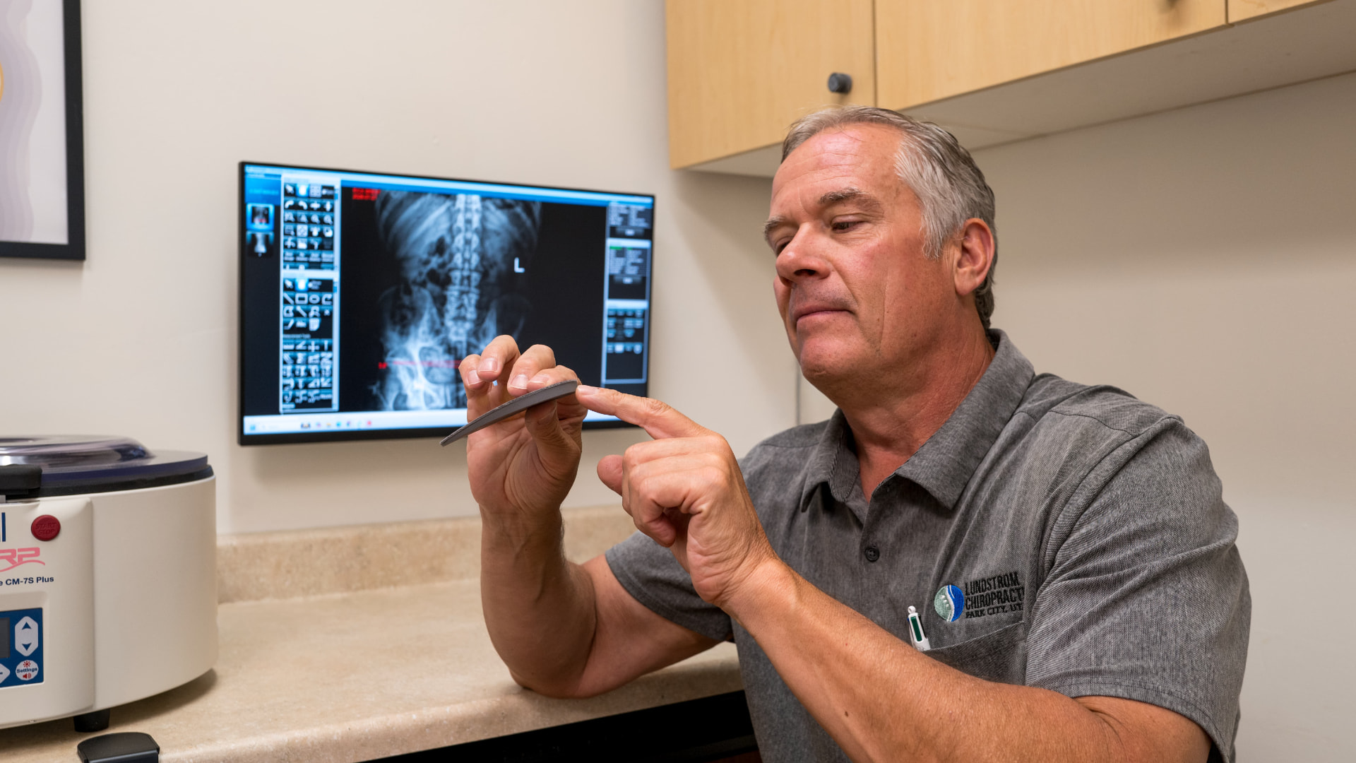 Dr. Lundstrom holding a Lundy heel lift in clinical practice